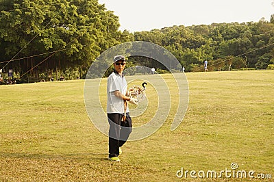 Shenzhen, China: people flying kites Editorial Stock Photo