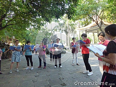 Shenzhen, China: people sing gospel songs in the park Editorial Stock Photo