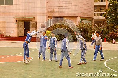 Shenzhen, China: pupils play basketball on the basketball court Editorial Stock Photo