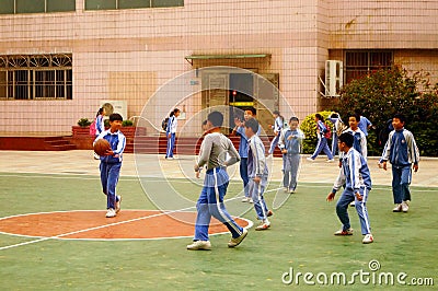 Shenzhen, China: pupils play basketball on the basketball court Editorial Stock Photo