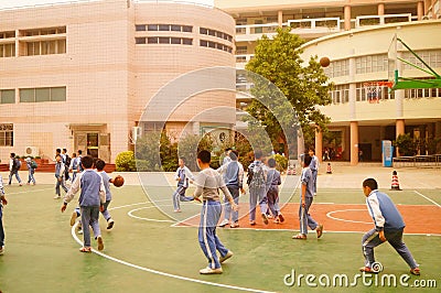Shenzhen, China: pupils play basketball on the basketball court Editorial Stock Photo