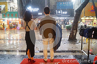 Shenzhen, China: rain, umbrella girls Editorial Stock Photo