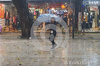 Shenzhen, China: rain, umbrella girls Editorial Stock Photo