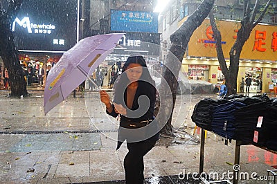 Shenzhen, China: rain, umbrella girls Editorial Stock Photo