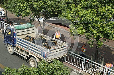 Shenzhen, China: sanitation workers in clearing up the rubbish Editorial Stock Photo