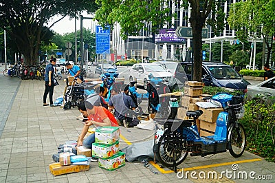 Shenzhen, China: on the sidewalk courier company employees are distributing customer courier Editorial Stock Photo