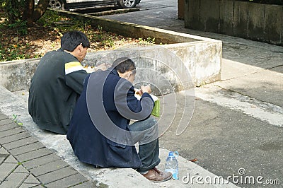 Shenzhen, China: Workers in eating fast food Editorial Stock Photo