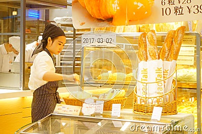 Shenzhen, China: young female employees in bakery Editorial Stock Photo