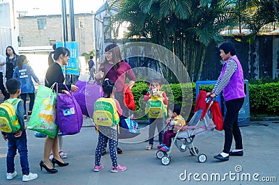 Shenzhen, China: a young mother takes her child home from kindergarten Editorial Stock Photo