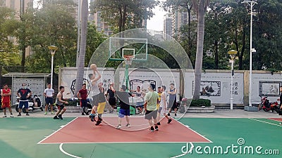 Shenzhen, China: young people play basketball on the basketball court at the stadium Editorial Stock Photo