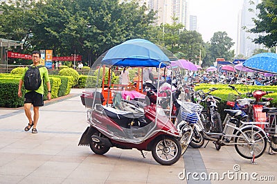 Shenzhen street landscape, tourists and bicycle parking Editorial Stock Photo