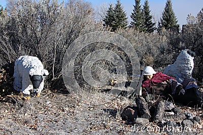 A shepherd and two sheep recline on the ground Editorial Stock Photo