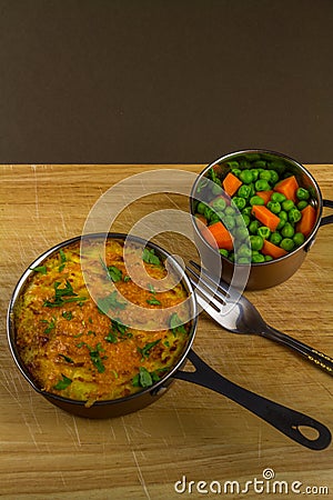 Shepherds or cottage pie in serving dish with parsley, portrait Stock Photo