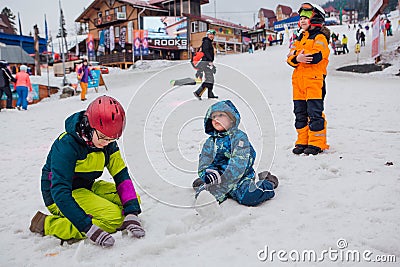 Sheregesh, Kemerovo region, Russia - 05 Apil 2019 : Kids playing with melting snow, making shapes of snow Editorial Stock Photo