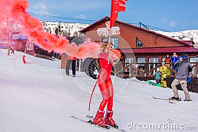 Sheregesh, Kemerovo region, Russia - April 12, 2019: Young happy pretty woman dressed in carnival costume of a red devil riding on Editorial Stock Photo