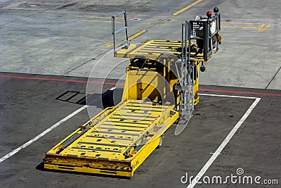 SHEREMETYEVO, MOSCOW REGION, RUSSIA - APRIL 28, 2019: Yellow cargo equipment car loader for luggage in the airport hub Editorial Stock Photo