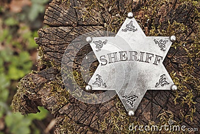 Sheriff badge on wooden background. Stock Photo