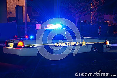 Sheriff car at night with lights on Stock Photo