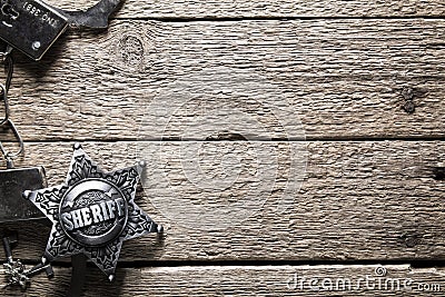 Sheriff star and handcuffs on wooden table Stock Photo