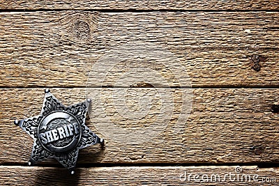 Sheriff star on wooden table Stock Photo