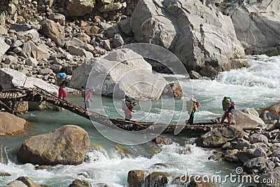 Sherpa porter carry basket in Nepal trekking path Editorial Stock Photo