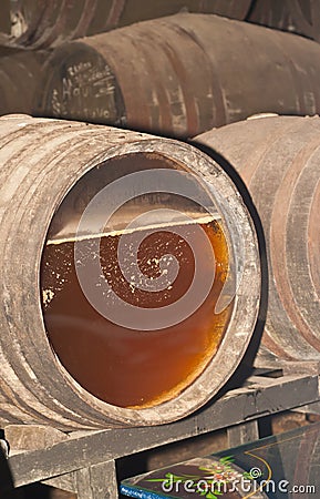 Sherry fermenting throgh a glass end front of an oak barrel Stock Photo