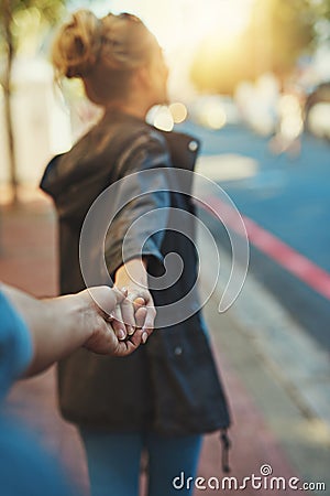 Shes a big city lover. a young woman pulling on her boyfriends hand. Stock Photo