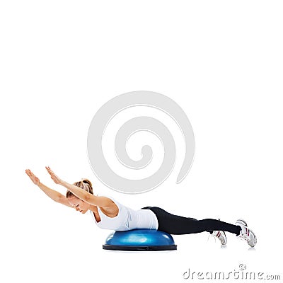 Shes doing a new super workout. A young woman strengthening her core on a bosu-ball. Stock Photo