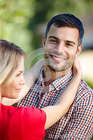 Shes just so perfect. Portrait of a happy young couple standing outside. Stock Photo