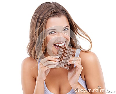 Shes a lover of chocolate. An attractive young woman eating a slab of chocolate. Stock Photo