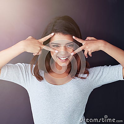 Shes a lover of fun. Cropped portrait of a beautiful young woman posing in the studio. Stock Photo