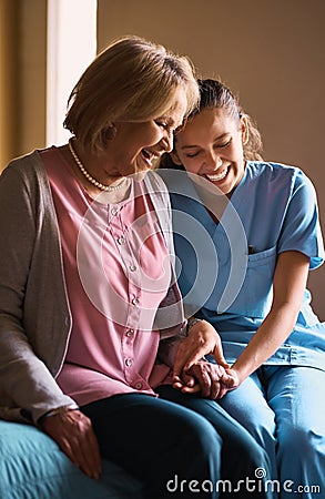 Shes not just here for her medical needs. a female nurse chatting to her senior patient. Stock Photo