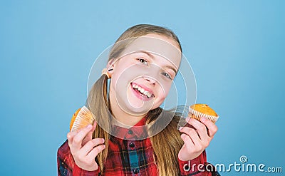 Shes so sweet that makes the food taste good. Small girl smiling with freshly baked dessert food. Happy little child Stock Photo