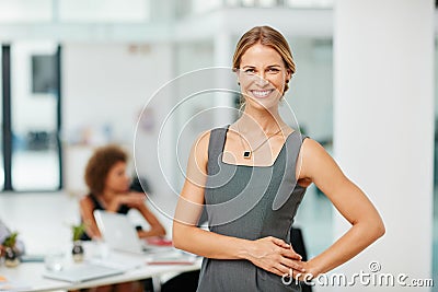 Shes way ahead of the business curve. Portrait of a smiling young businesswoman standing in a modern office. Stock Photo