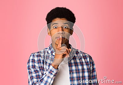 Shh, make silence please. Guy keeping fore finger on lips Stock Photo