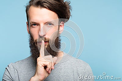 Shh silence quiet man showing finger lips gesture Stock Photo