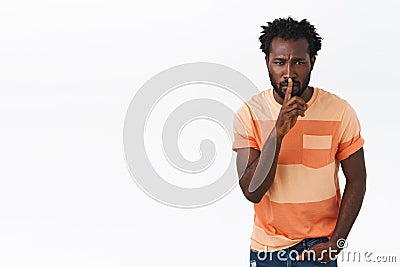 Shhh silence in class. Serious-looking african american bearded guy in striped t-shirt demand quiet, shushing, press Stock Photo