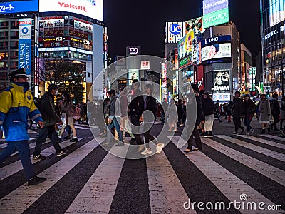 Shibuya, Japan - 7.2.20: Large crowds crossing Shibuya`s famous scramble crossing Editorial Stock Photo