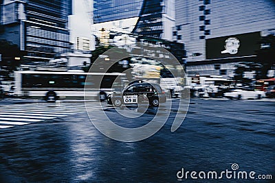 Shibuya taxi driving through the city street in the evening Editorial Stock Photo