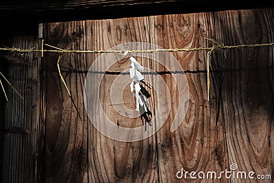 Shide paper hanged on Shimenawa rope around a building Stock Photo