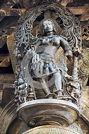 Shilabalika, celestial maiden, in a beauty dance pose. A lady practicing dance steps. Her maids are playing their musical instrume Stock Photo