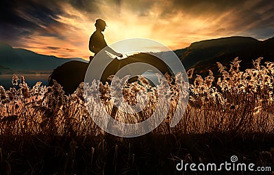 Shilhouette of girl on horseback at sunset Stock Photo