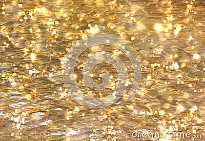 Shimmering Gold Water Bokeh Background Stock Photo