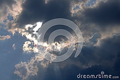 SHIMMERING LIGHT OF THE SUN BEHIND CLOUDS Stock Photo