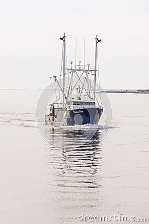 Shimmering reflection of scalloper Virginia Dare on calm October morning on the Acushnet River Editorial Stock Photo