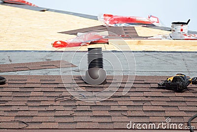 Shingles roof ventilation for heat control with nailgun. Stock Photo