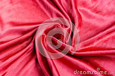 Shining red silk atlas satin fabric with folds, fabric waves. Real fabric background Stock Photo