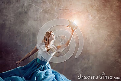 Shining star in hand, reach for the dream concept. Young woman holding a star in her hand Stock Photo