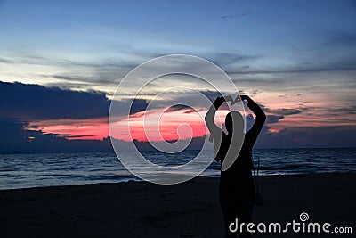 Shining women At dusk at sea Night Picture Stock Photo