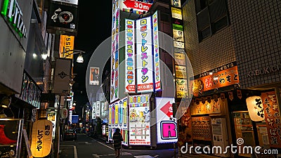 A Shinjuku side street at night, with colorful sign for a Robot Restaurant, and neon light billboard, Tokyo, Japan Editorial Stock Photo